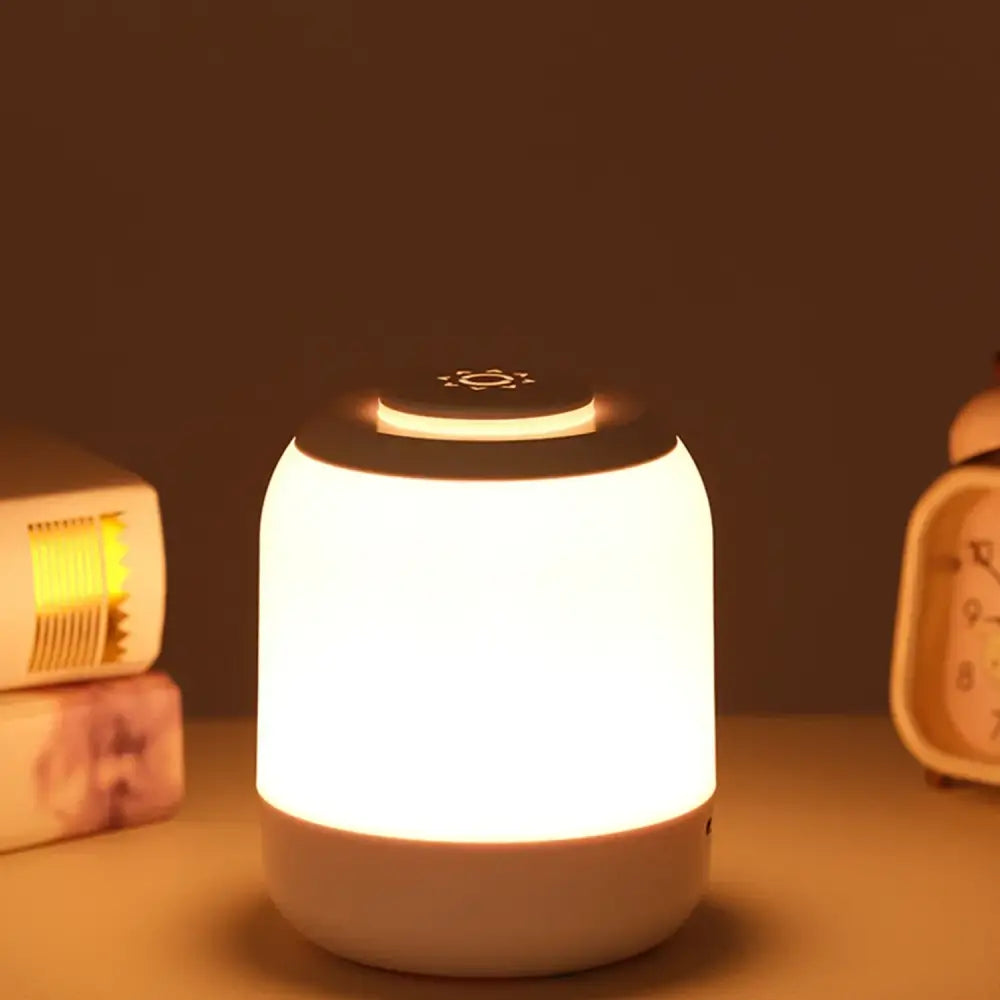 Decorbites™ led touch night light featuring a soft white matte cylindrical body with a black sun icon top for baby sleep