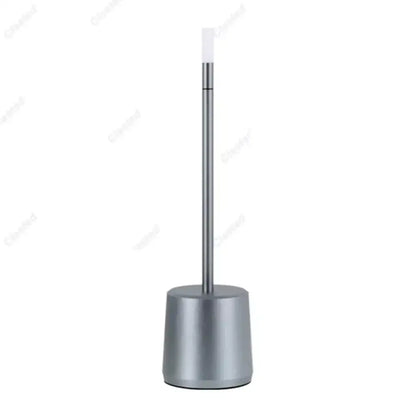 Modern silver-toned metal toilet brush stand with sleek cylindrical base alongside decorbites led touch table lamp