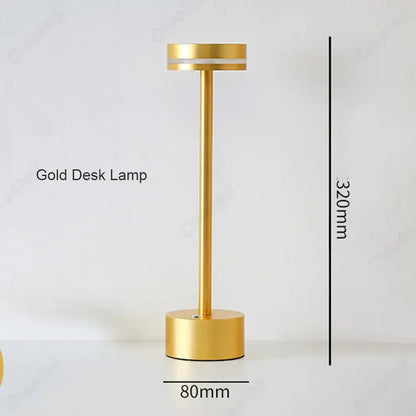 A sleek minimalist gold decorbites led touch table lamp with cylindrical base and slender stem for living room use