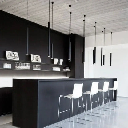 Black minimalist bar featuring a decorbites led tube pendant light 5w with sleek white stools for modern kitchen dining decor