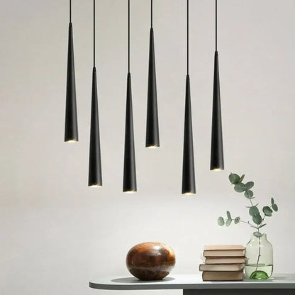 Five sleek black conical decorbites led tube pendant lights hang in a modern kitchen dining room arrangement