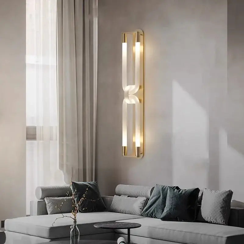 Modern decorbites led tube wall sconce with gold frame, black and white metal, acrylic panels, warm glowing light
