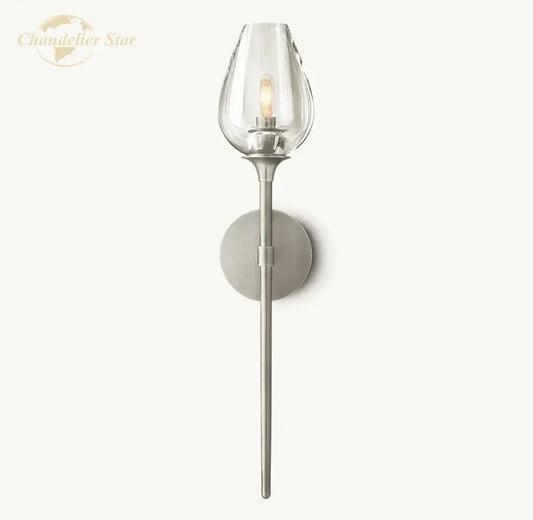 A sleek decorbites led tulip wall sconce with a clear glass shade and brushed nickel stem for indoor lighting