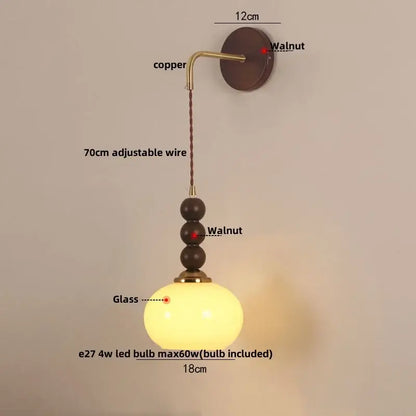 Warm-toned orange glass decorbites led wall pendant light with copper hardware and walnut beads for bedroom decor
