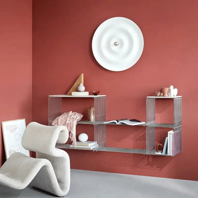 Modern silver wire shelving unit with geometric modular design complementing decorbites led white sconce living room light