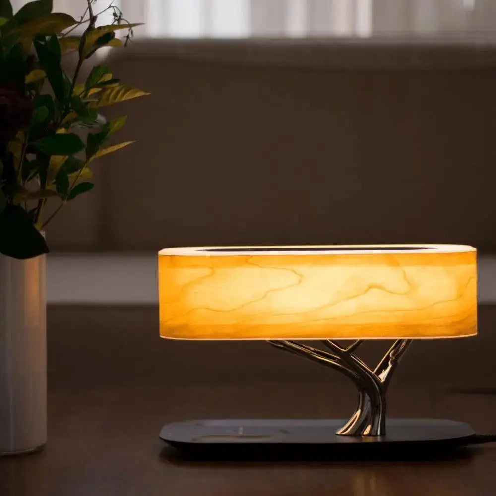 Warm amber-lit decorbites table lamp with tree-like metallic base and translucent wood-grain shade life table lamp