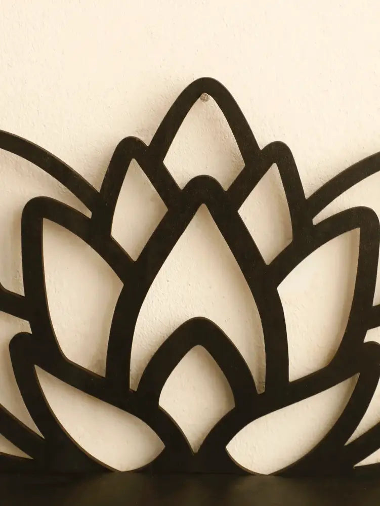 Black metal lotus floating wall shelf with sleek cut-out petal design for multi-style home decor by decorbites