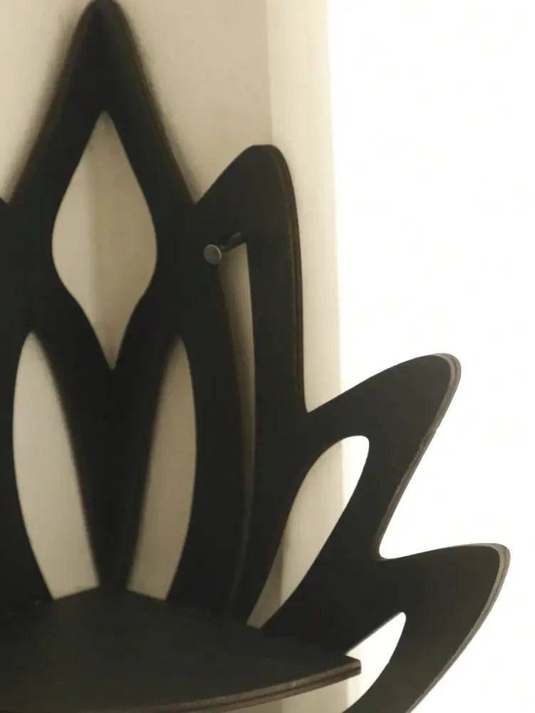Black wooden lotus floating wall shelf with sleek minimalist design for multi-style home decor by DecorBites