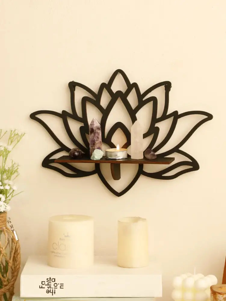 Black metal lotus floating wall shelf with wooden slat holding crystals and lit candle for multi-style decor