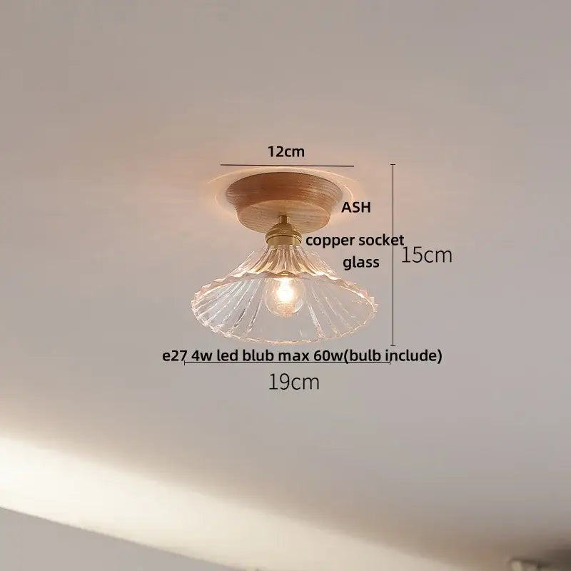 A warm-toned decorbites lotus glass led ceiling light with clear fluted glass shade and copper base in modern nordic design