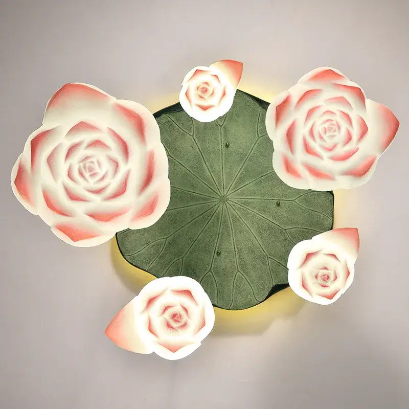 DecorBites lotus glass pendant lamp features a green lotus leaf with four glowing pink and white rose-shaped glass lamps