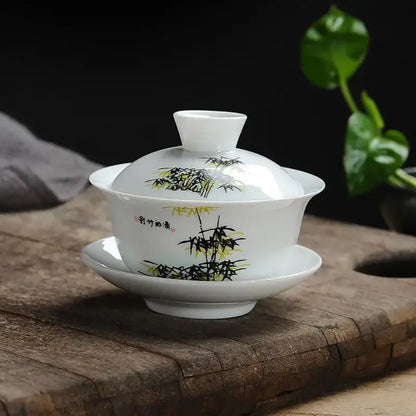 White porcelain gaiwan tea set with hand-painted black and yellow bamboo design and chinese calligraphy decorbites lotus