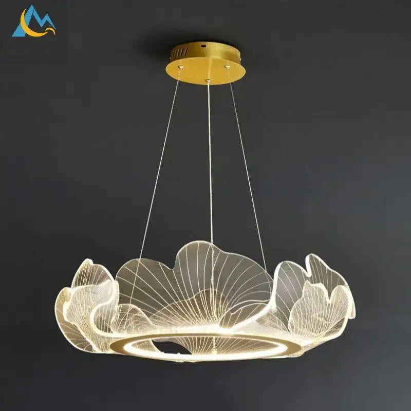 A modern gold-toned DecorBites lotus leaf pendant light with translucent acrylic leaves emitting warm glow