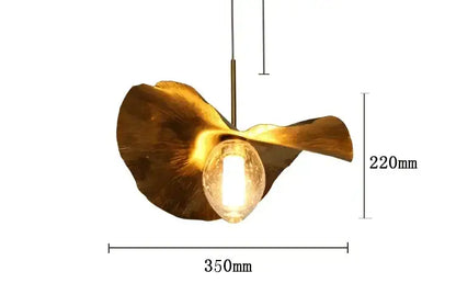 Golden lotus leaf brass pendant lamp by decorbites with textured glass encasing warm glowing bulb for minimalist spaces