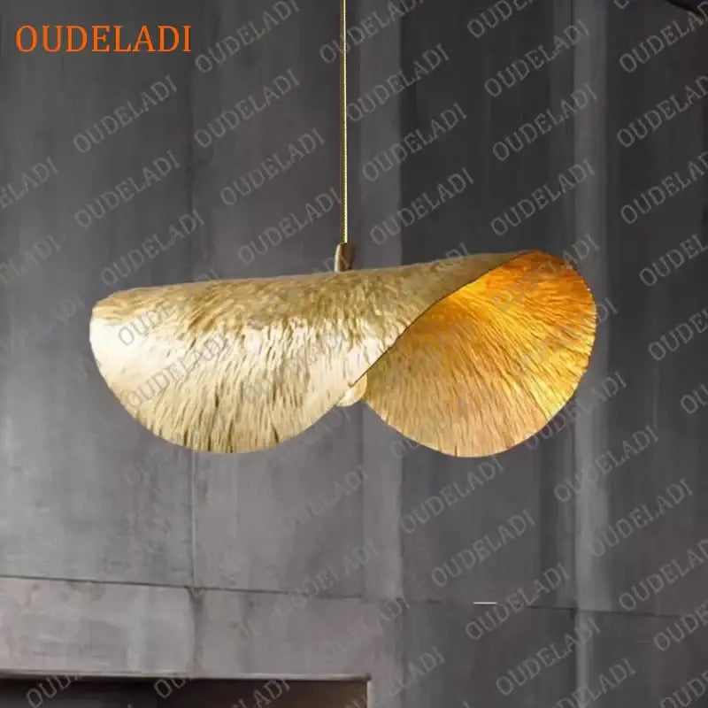 Golden leaf-shaped pendant light with textured metallic finish and twisted design in decorbites lotus leaf copper chandelier
