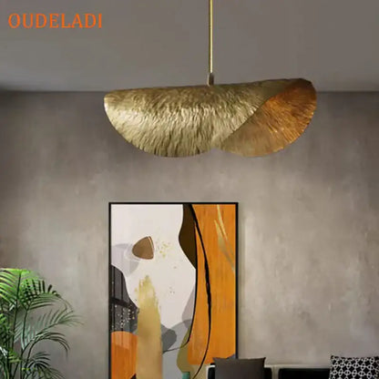 A golden lotus leaf copper pendant light with textured metallic finish by decorbites lotus leaf for kitchen island decor