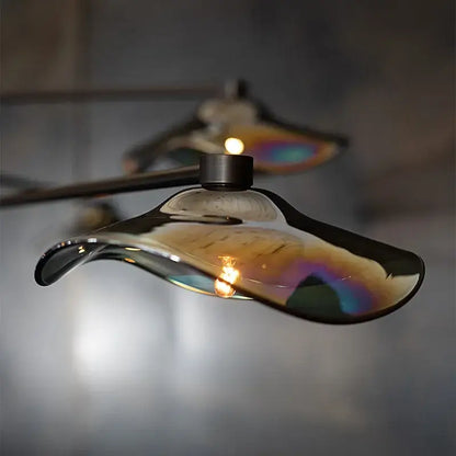 A sleek iridescent lotus leaf glass ceiling chandelier by decorbites with smooth curved design for living room lighting
