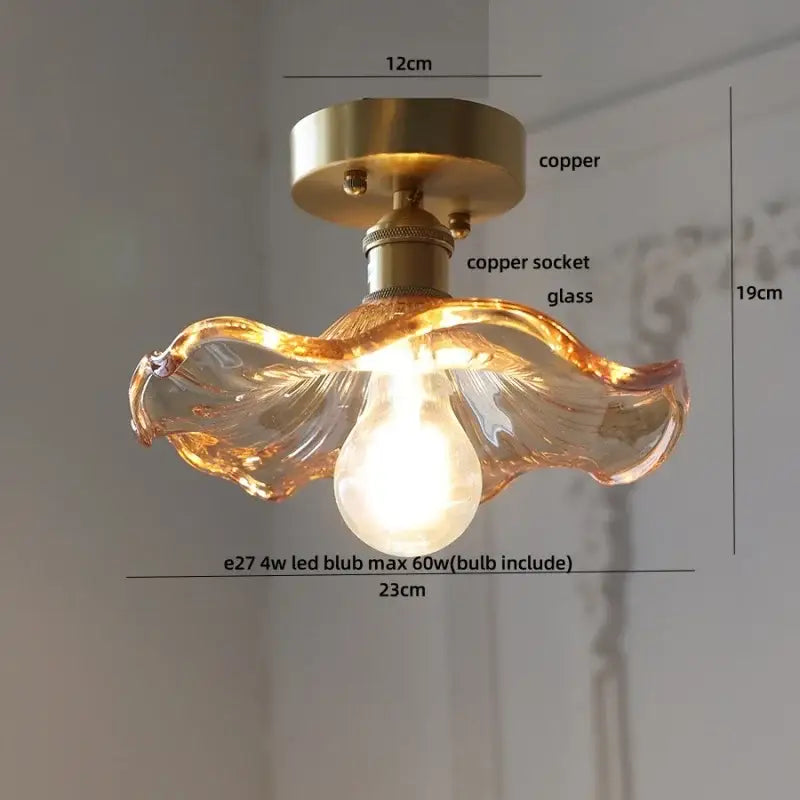A warm-toned hand-blown glass DecorBites lotus leaf LED ceiling lamp with a copper-finished mounting base