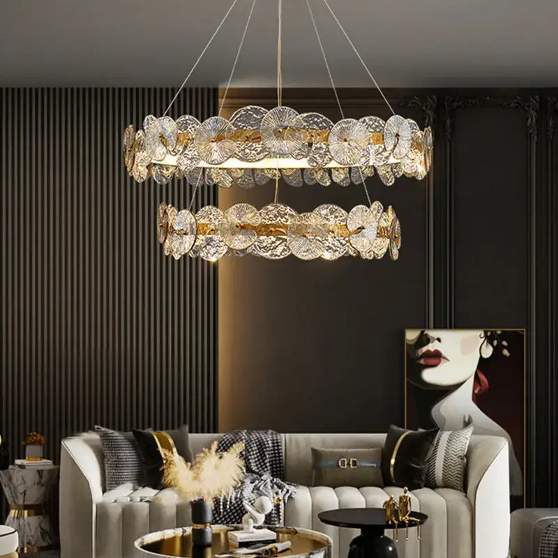 A double-tiered decorbites lotus leaf led chandelier with clear fan-shaped crystal discs and gold-toned accents