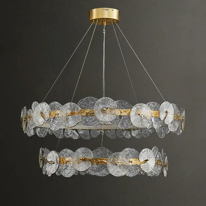 Decorbites lotus leaf led chandeliers featuring two-tiered clear textured glass discs with gold leaf led accents and brass mount