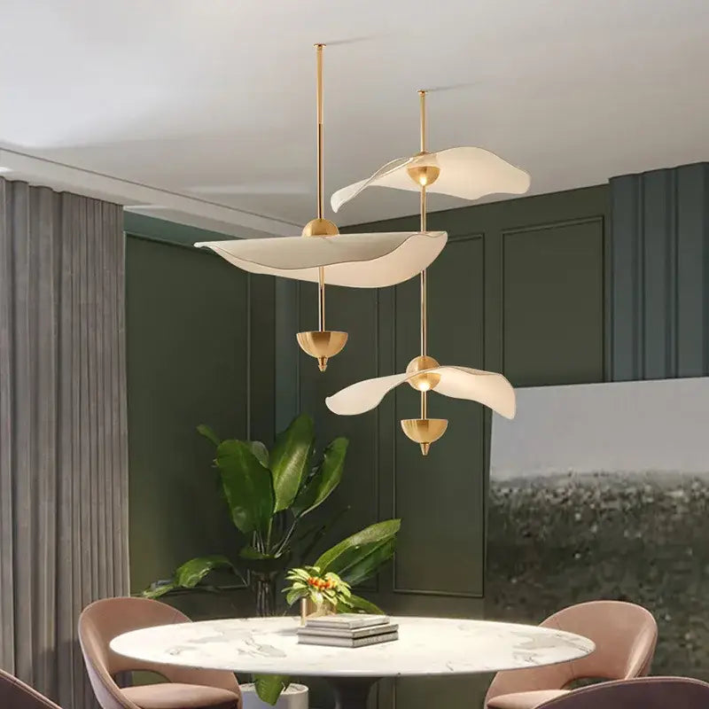 Gold-toned DecorBites lotus leaf pendant lamp with sculptural white petal diffusers for luxury living room decor