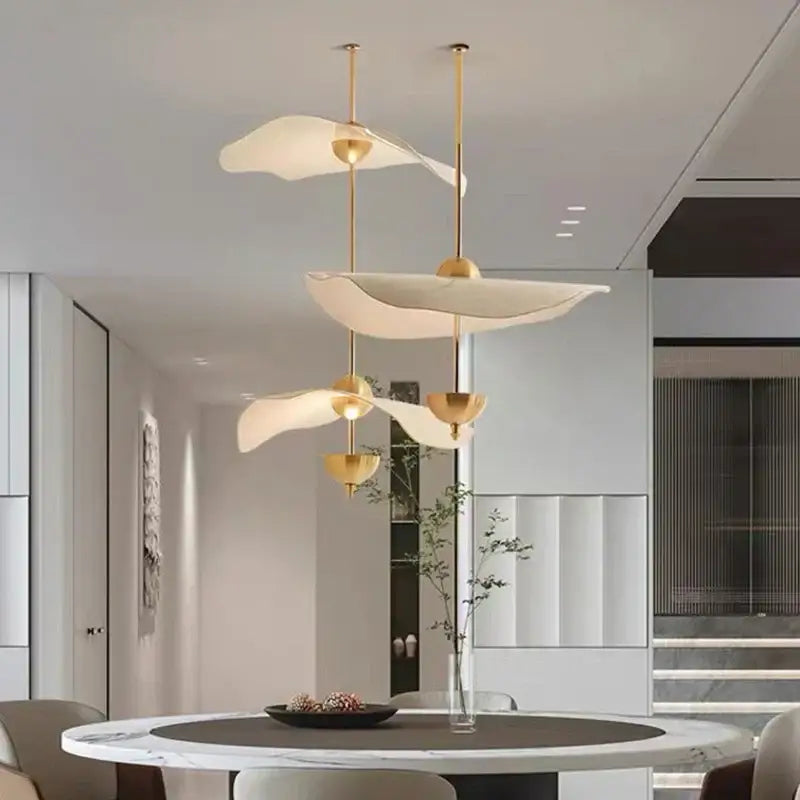 Modern gold-toned decorbites lotus leaf pendant lamp with sculptural white diffusers for luxury living room decor