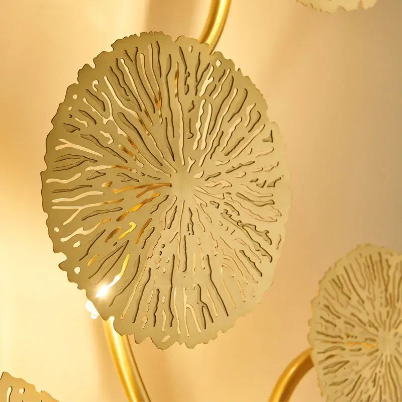 Gold-toned metal decorbites lotus leaf wall lights with intricate leaf cutouts in radial pattern for living room decor