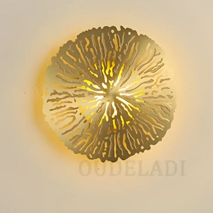 Golden circular decorbites lotus leaf led wall sconce with intricate radial cutout design in copper industrial style