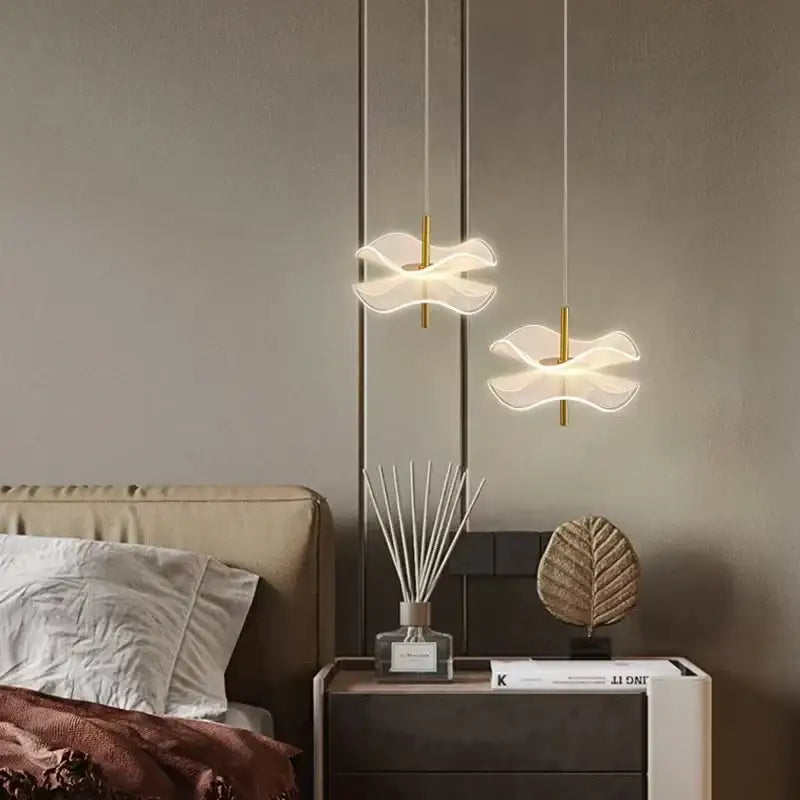Two elegant translucent white decorbites lotus leaf pendant lights with gold-toned rods for restaurant and bedroom use