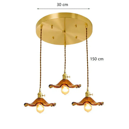 Gold-toned decorbites lotus leaf pendant lights with three amber glass shades and twisted brown cords for modern interiors