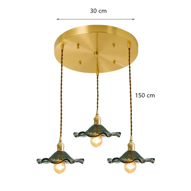 Gold-toned decorbites lotus leaf pendant lights with three dark green ruffled glass shades suspended by twisted bronze cords