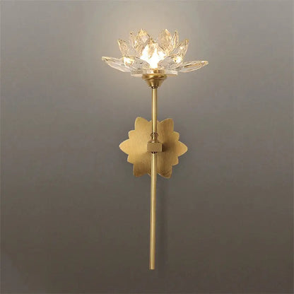 Delicate gold-toned decorbites lotus led wall lamp with crystal lotus design and ornate leaf base for bedroom decor