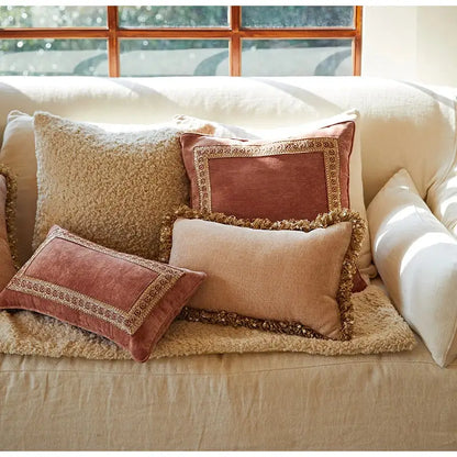 A set of decorbites lotus pink pillow covers in earthy tones with velvet textured fabric and gold embroidered borders