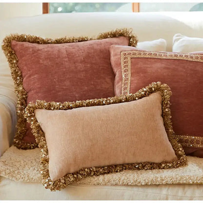 Two rectangular decorbites lotus pink pillow covers with textured linen fabric and vintage fringed tassels in dusty rose and beige