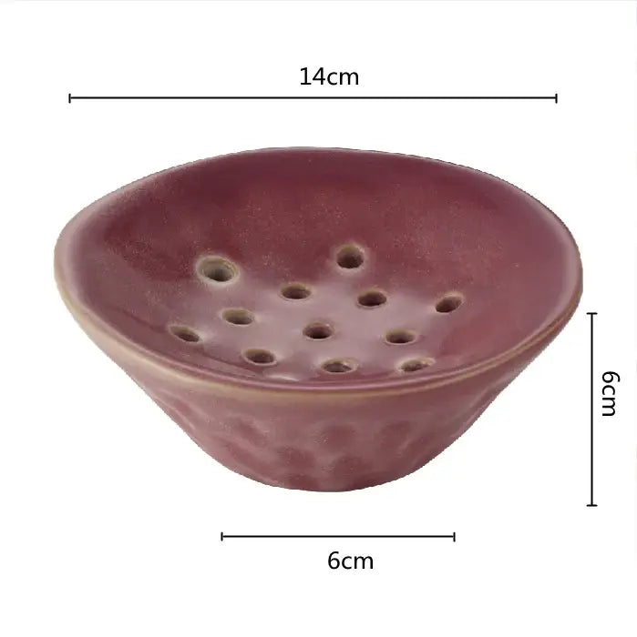 A rustic matte lotus root clay bowl with deep reddish brown glaze and circular drainage holes for home decor use