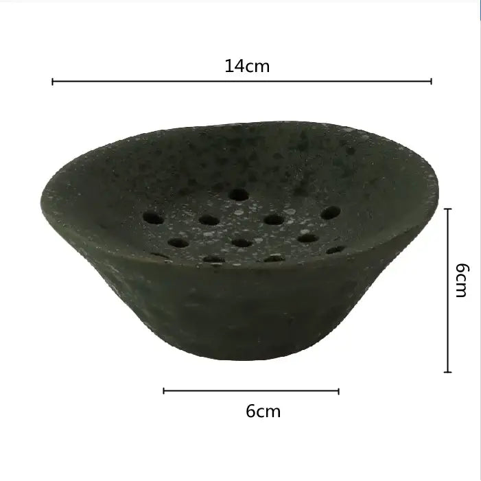 Dark green lotus root clay root clay bowl with textured speckled surface and circular holes for home decor use