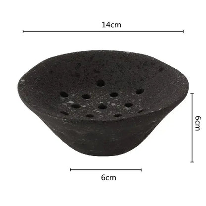 Black textured stone root clay bowl with multiple circular holes for home decor in the DecorBites lotus root clay collection