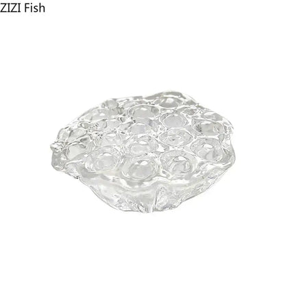 Clear glass egg holder with textured bubble surface complementing decorbites lotus seedpod resin sculpture desk decor
