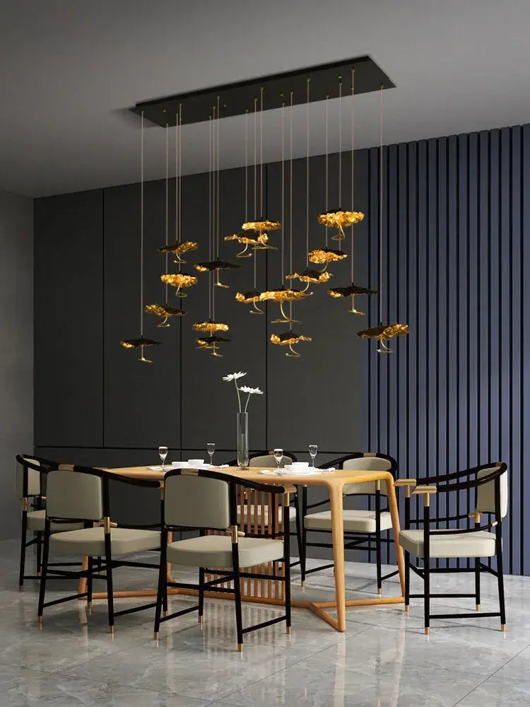 Golden flower-shaped pendant lights hang from a black fixture in the DecorBites Lotus Staircase LED chandelier