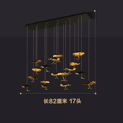A modern decorbites lotus staircase chandelier with 17 golden lotus LED lights on black copper frame hanging lamp