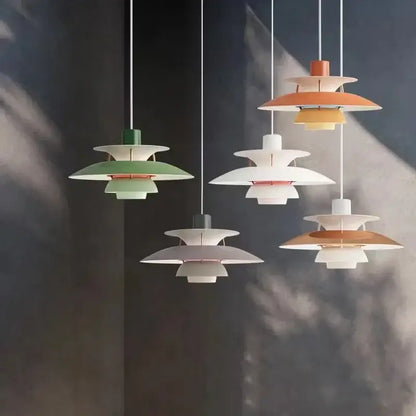 Modern multi-tiered loui led pendant light in pastel green white and terracotta with metallic accents for kitchen or living room