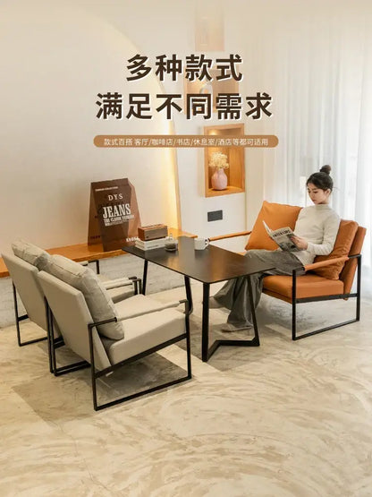 Modern minimalist coffee table with sleek black metal frame and dark wood top complementing single sofa chair designs