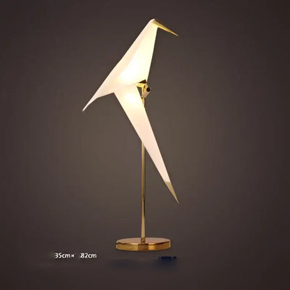 A sleek decorbites™ love bird led wall sconce with white translucent acryl body and gold-toned iron frame for bedroom
