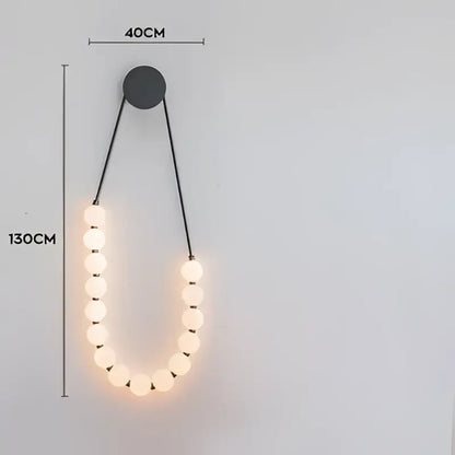 A modern black wall-mounted decorbites love gold chrome chandelier with warm led bulbs in an elegant u-shape design