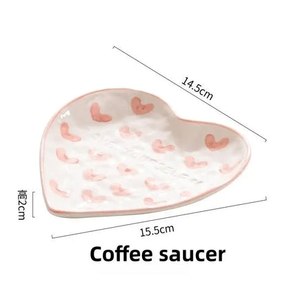 A white ceramic coffee saucer with decorbites love heart hand painted pink hearts and a glossy finish