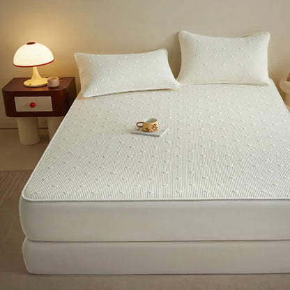 White textured mattress pad with subtle ribbed pattern paired with decorbites love pattern cotton fitted sheet single