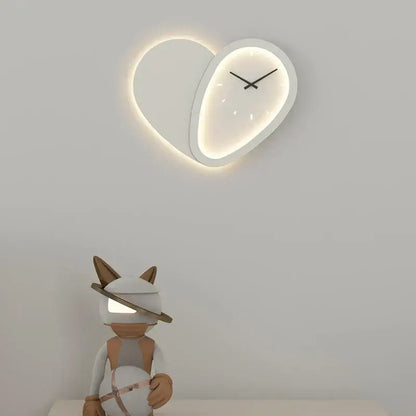 A modern decorbites love shaped clock wall lamp with a minimalist white face and dimmable indoor bedroom lighting