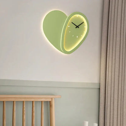 A modern decorbites love shaped wall lamp clock with a mint green exterior and glowing yellow interior for indoor use