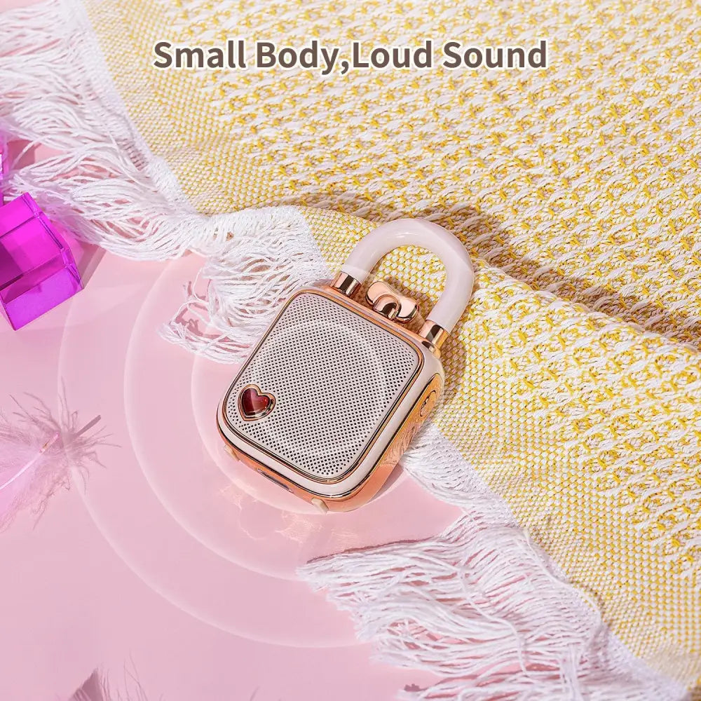 Rose gold lovelock mini bluetooth speaker with heart emblem and mesh grille in a retro pink design with 5w sound
