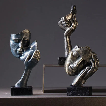 DecorBites loving couple resin statue features blue and gold metallic face sculptures held by hands for interior decor